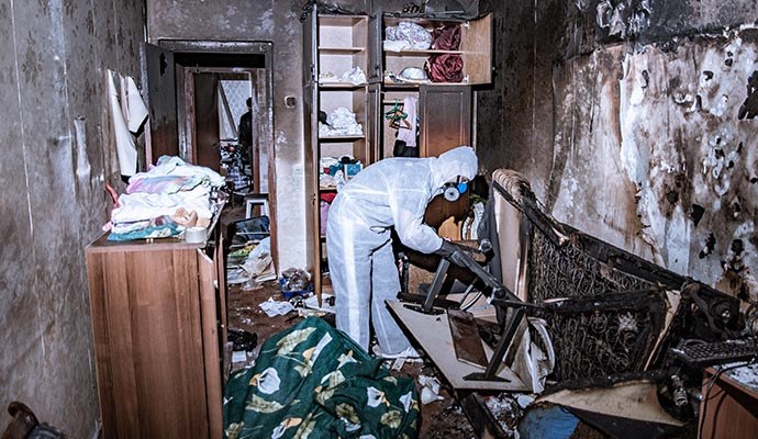 professional worker cleaning a fire damaged room