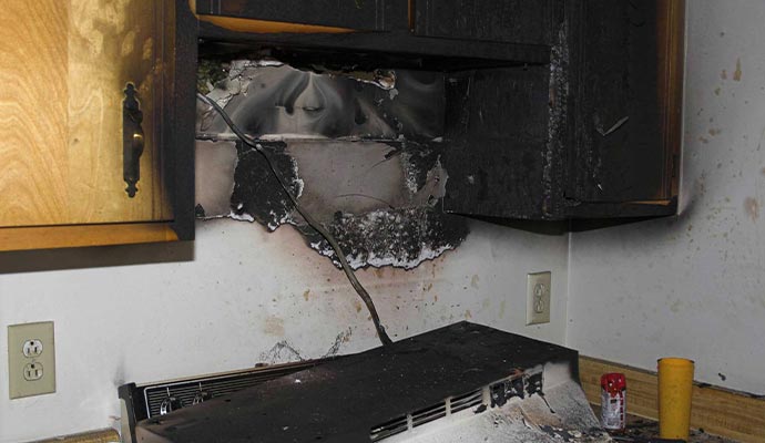 Fire damaged kitchen with visible smoke soot