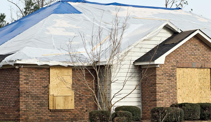 After storm damage boarded up house 