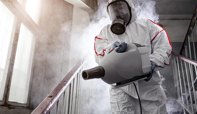 professional worker disinfecting stair case